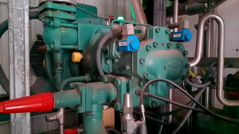 Industrial refrigeration screw compressor with a PHANTOM® wireless vibration sensor installed for predictive maintenance